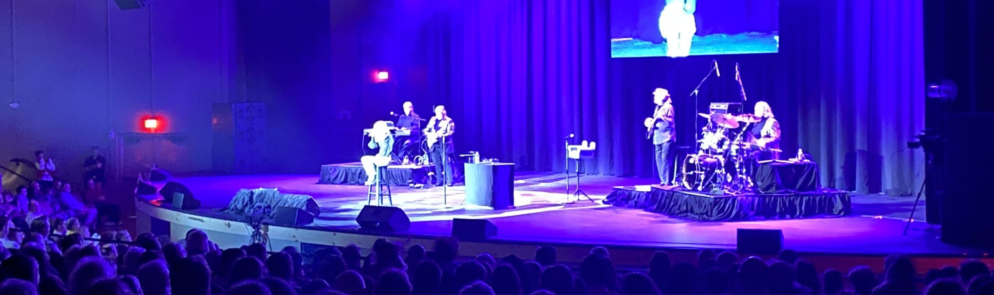 signer on stage in chair washed out by the lights Springfield